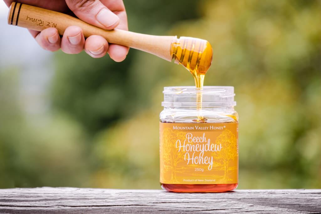 Beech Honeydew Honey being Drizzled with Wooden Honey Drzzler
